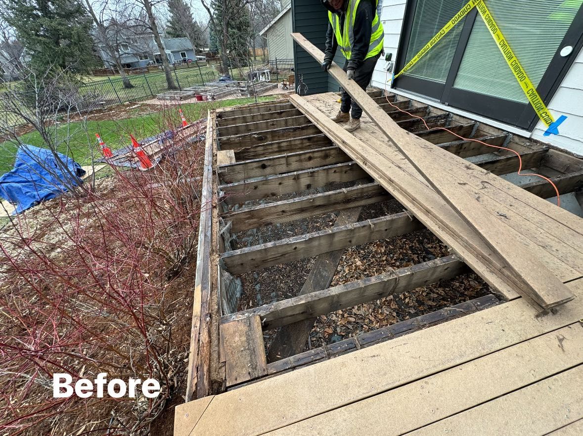 Deck demolition: Person removes weathered boards from a dilapidated deck, revealing underlying joists.