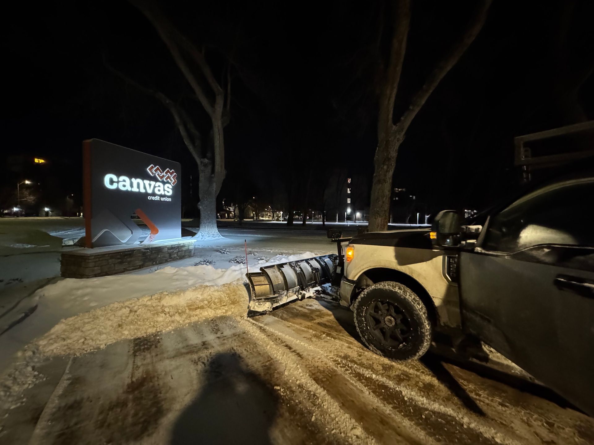 A snowplow clears snow in front of a