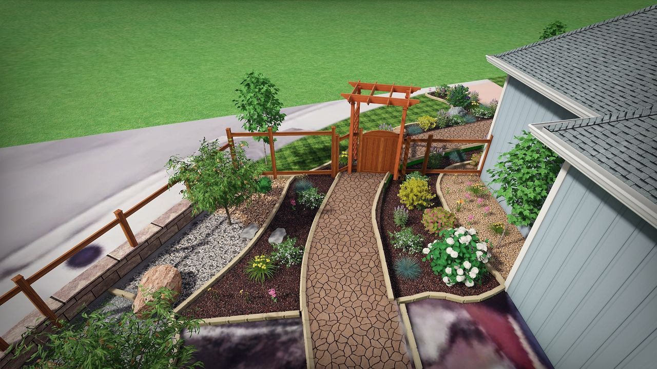 Landscaped front yard with a wooden pathway, gate, and colorful plants.