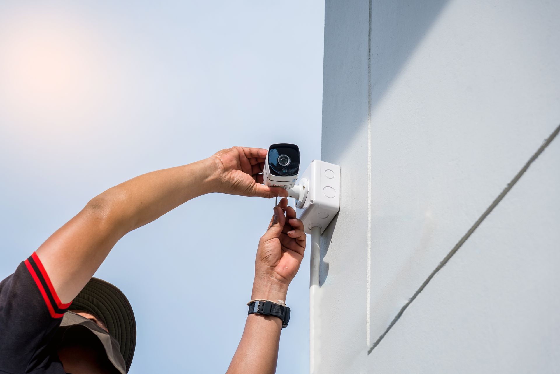 A technician is installing a security camera.