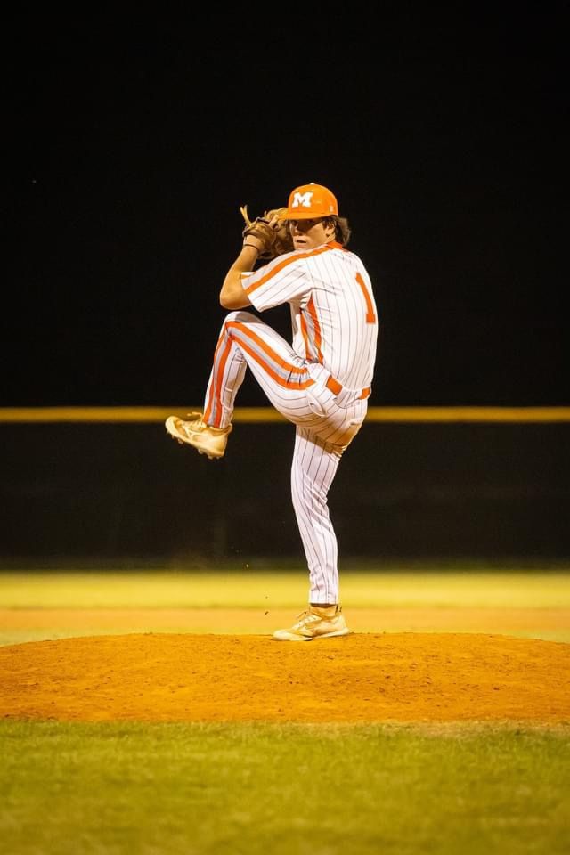Baseball player sliding into base as another player attempts to catch the ball.