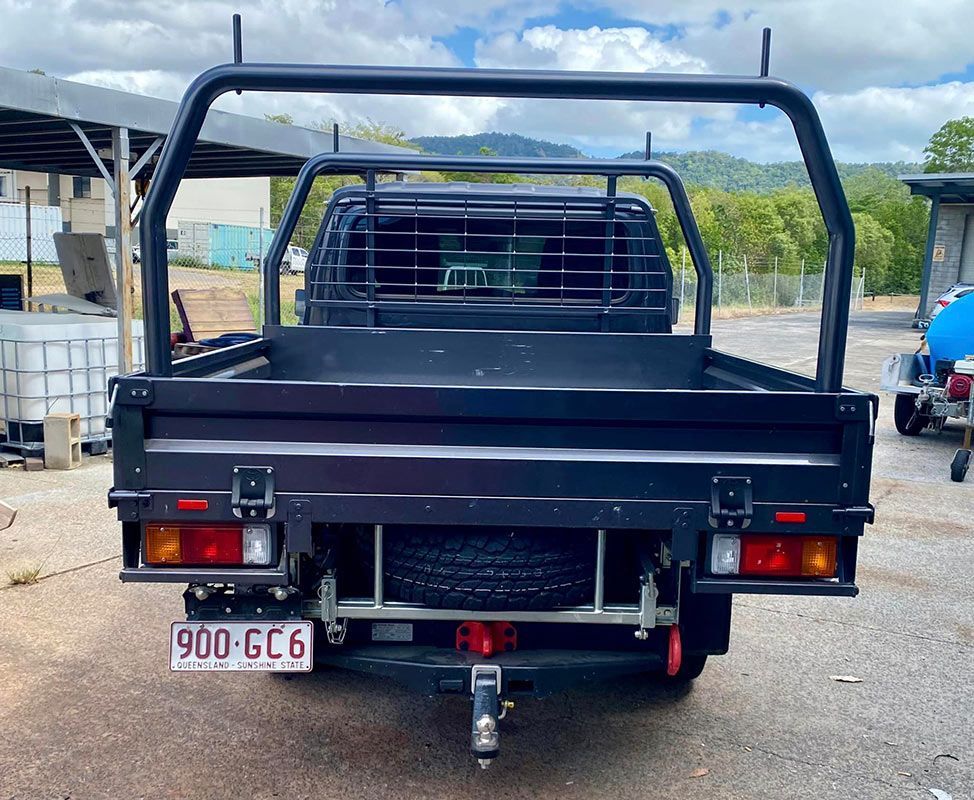 A black truck with a license plate that says 900 gc6 — PSE Stainless Steel Fabrications in Manunda, QLD