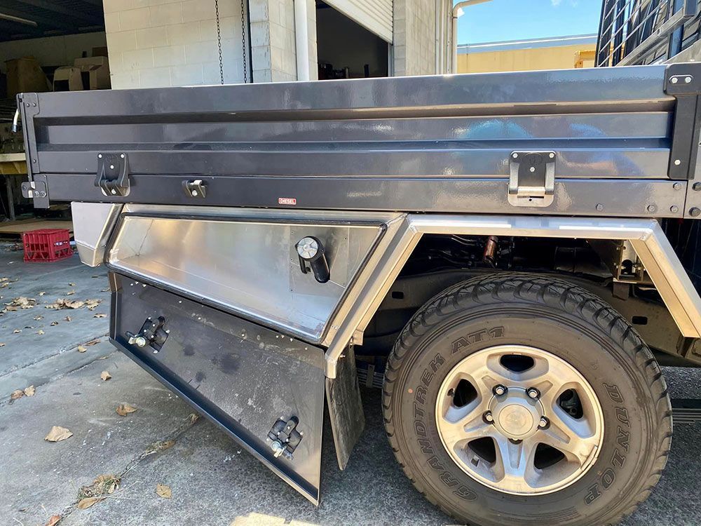 A truck with a tray and a tire is parked in a garage — PSE Stainless Steel Fabrications in Manunda, QLD