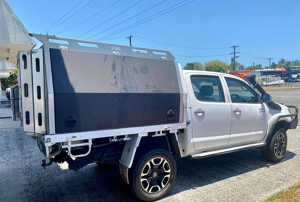 A white truck with a canopy is parked on the side of the road — PSE Stainless Steel Fabrications in Manunda, QLD