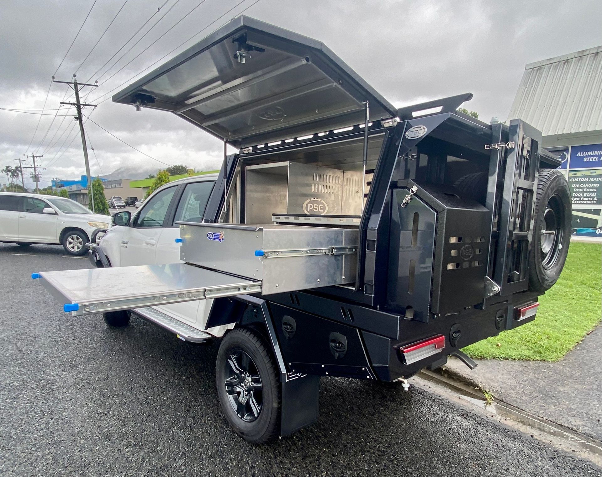 A Silver Truck with A Ladder Attached to The Back Is Parked on The Side of The Road — PSE Stainless Steel Fabrications in Manunda, QLD