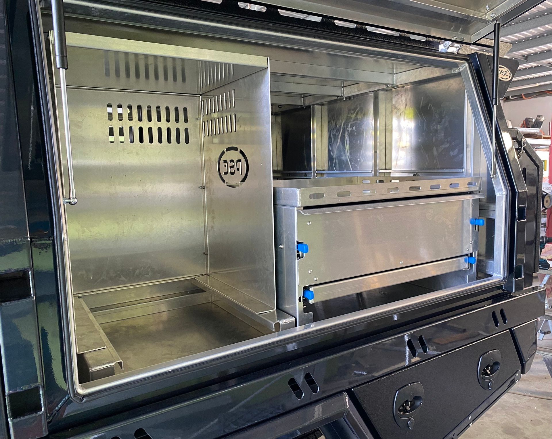 The inside of a truck canopy with a cage and drawers  — PSE Stainless Steel Fabrications in Manunda, QLD
