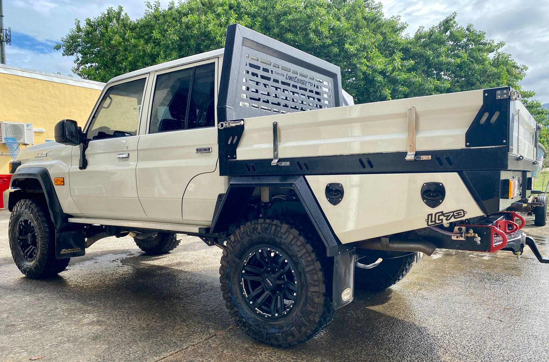 A white truck with a flat bed is parked on the side of the road  — PSE Stainless Steel Fabrications in Manunda, QLD