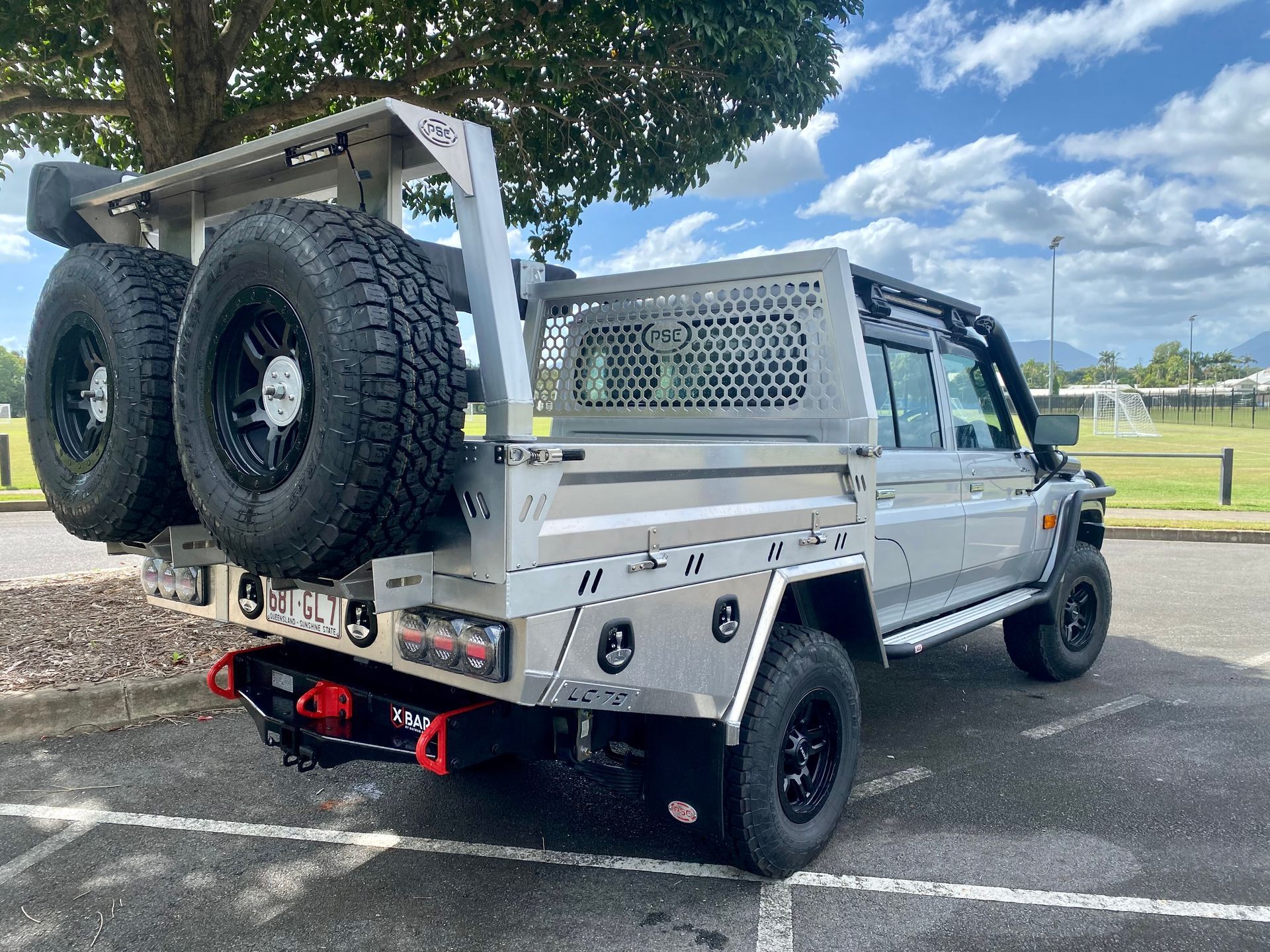 A silver truck with a tray on the back is parked in a parking lot  — PSE Stainless Steel Fabrications in Manunda, QLD