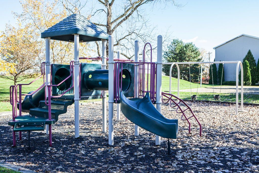 Playground with slides and tunnels on a sunny day.