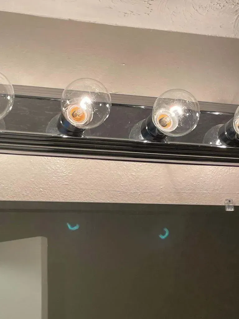 Bathroom light fixture with round bulbs.