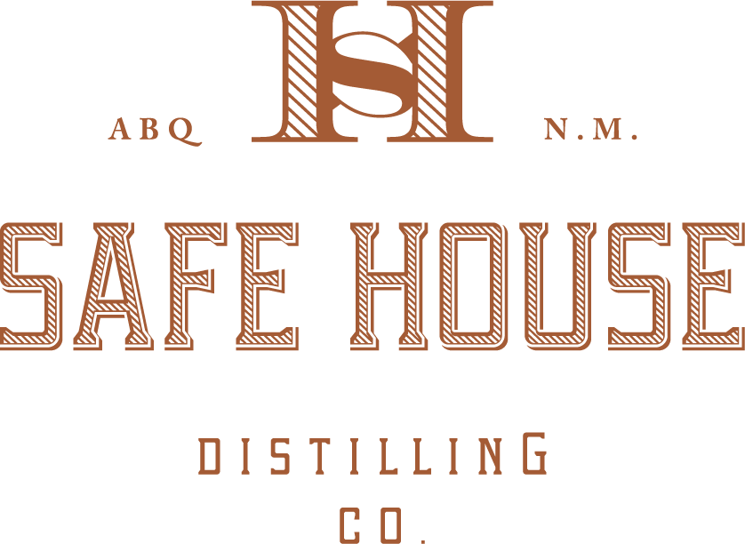 The logo for safe house distilling co. is brown and white.