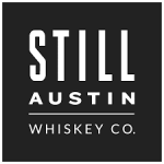 The logo for still austin whiskey co. is black and white.