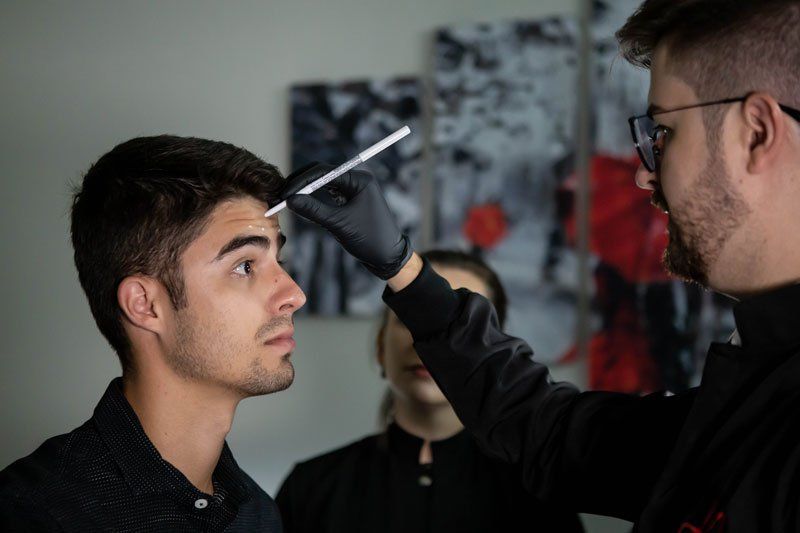 man getting marked for botox injections