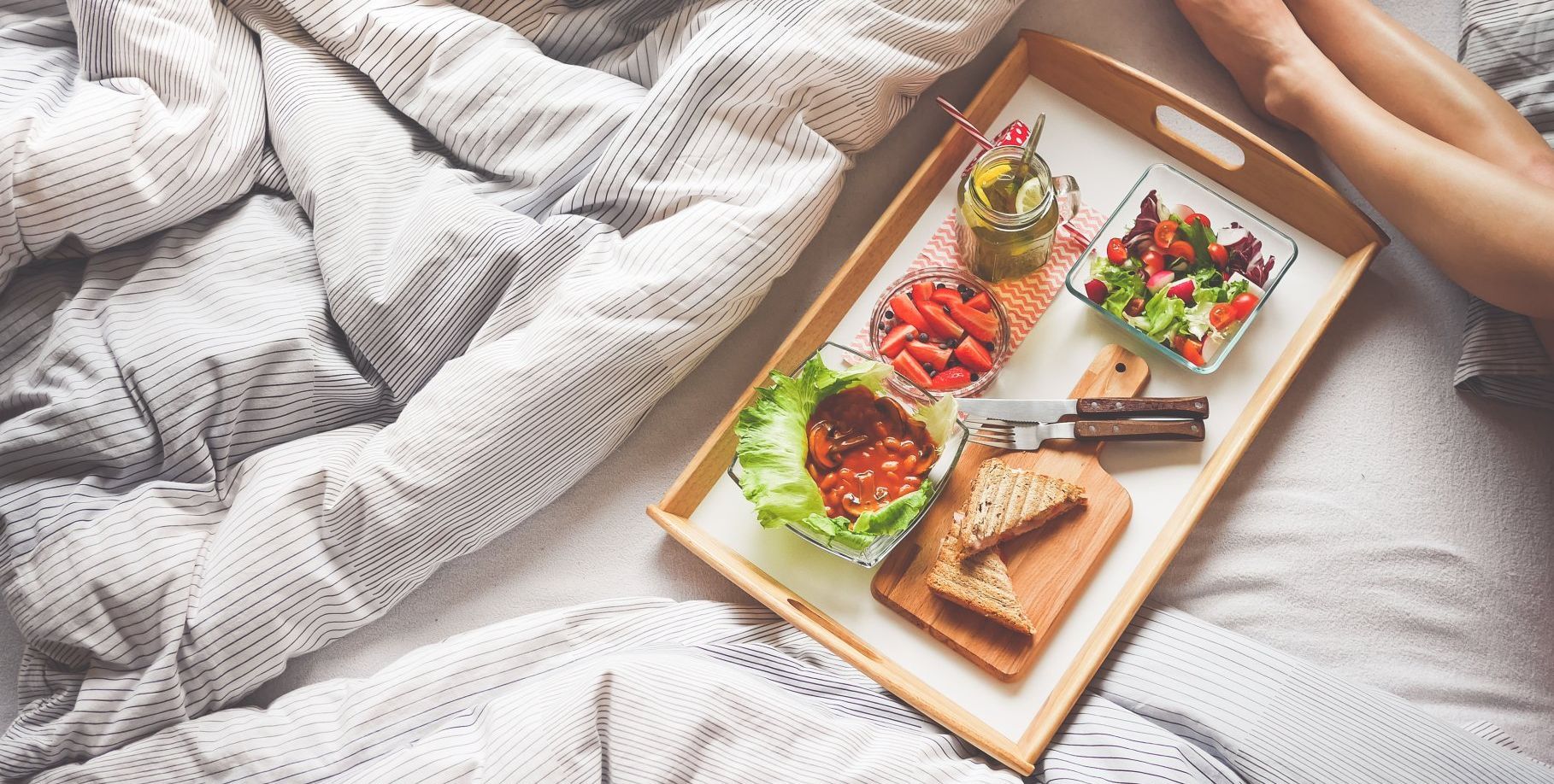 bed with tray of food on it