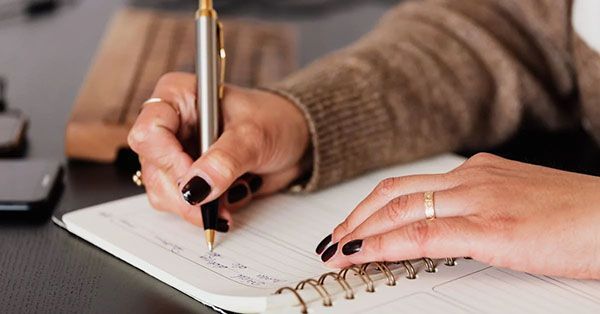 woman writing in notebook