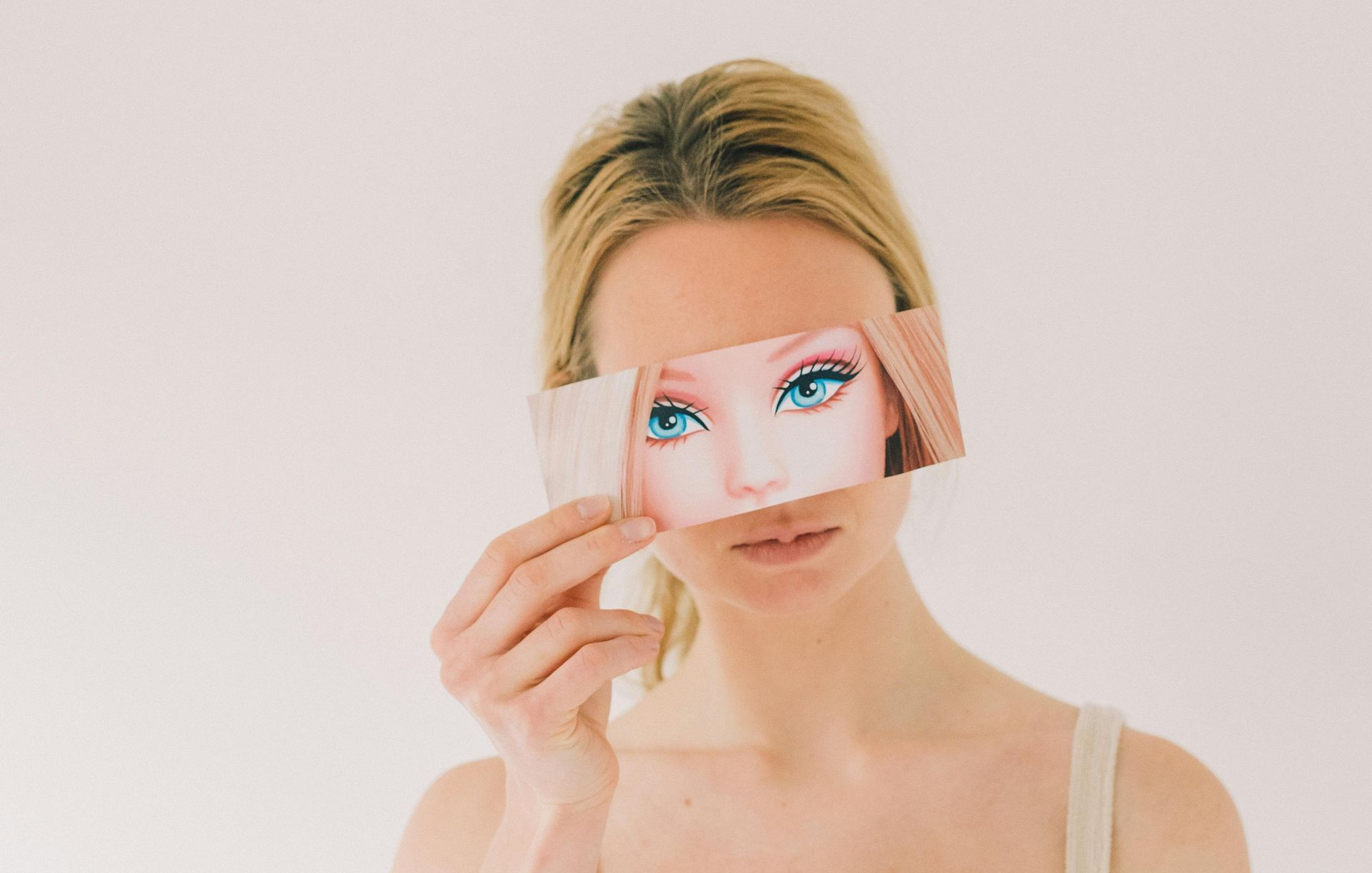 woman with image of barbie eyes in front of her face