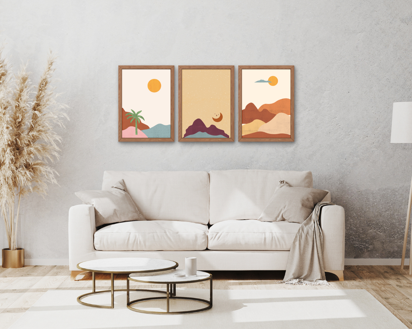 Cozy beige living room with a sofa, round tables, pampas grass, and three framed desert landscape prints