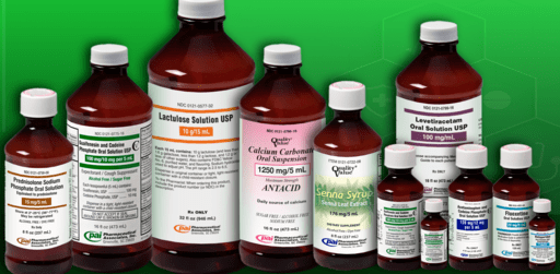 Assorted medicine bottles and vials arranged on a green background