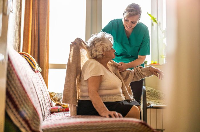 female nurse taking care senior woman
