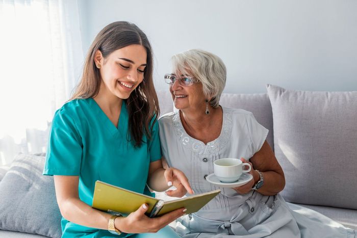 happy patient holding caregiver hand while