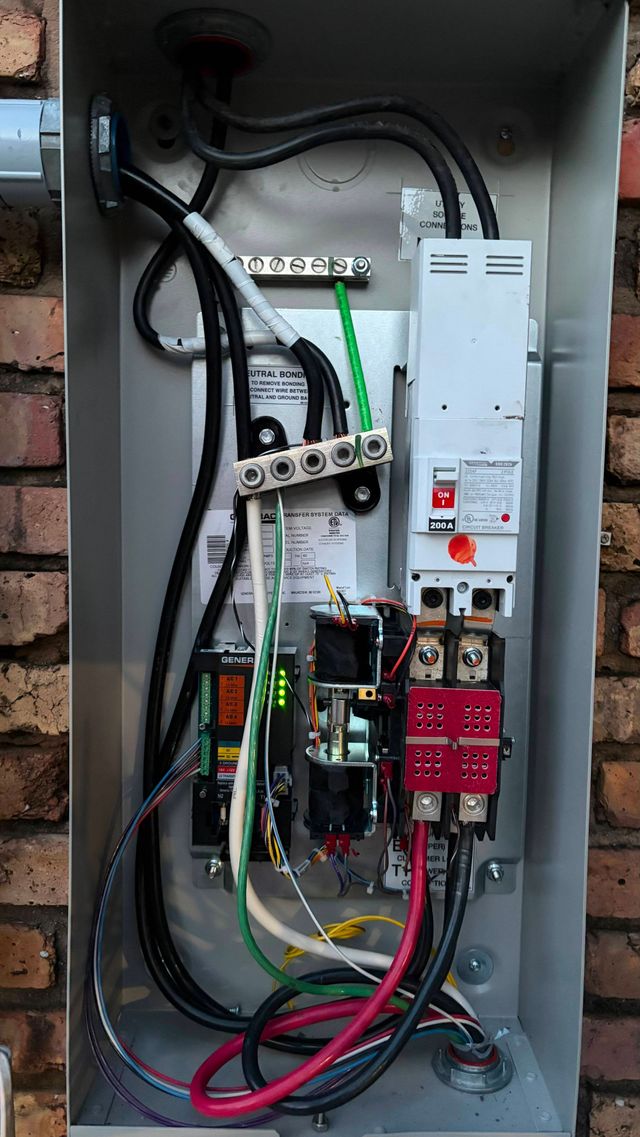 Person wearing white glove using screwdriver on electrical panel.