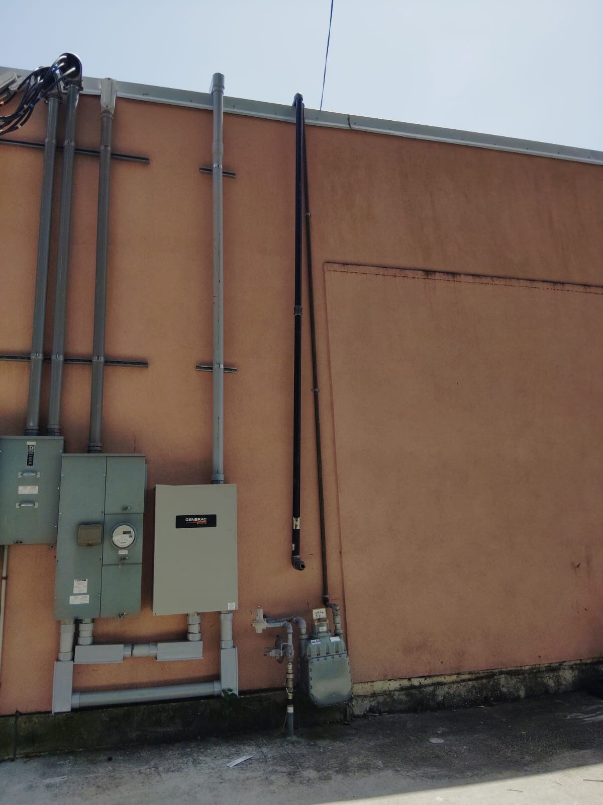 Person working on electrical panel, connecting wires.