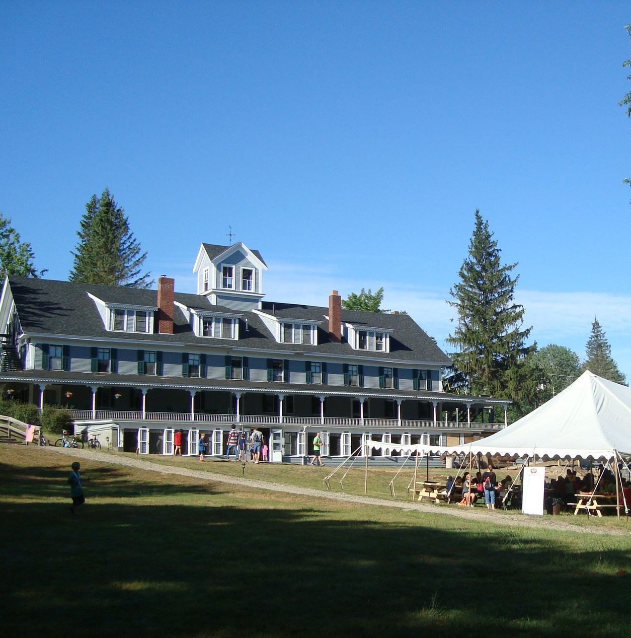 A large house with a white tent in front of it