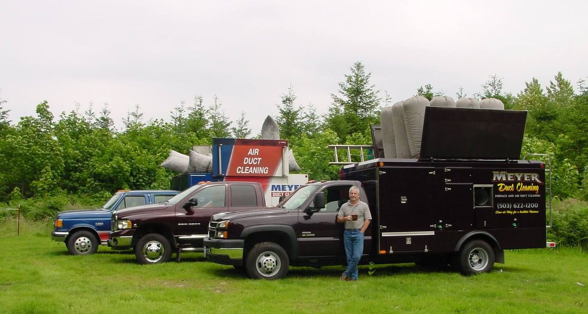 A man standing next to a truck that says meyer