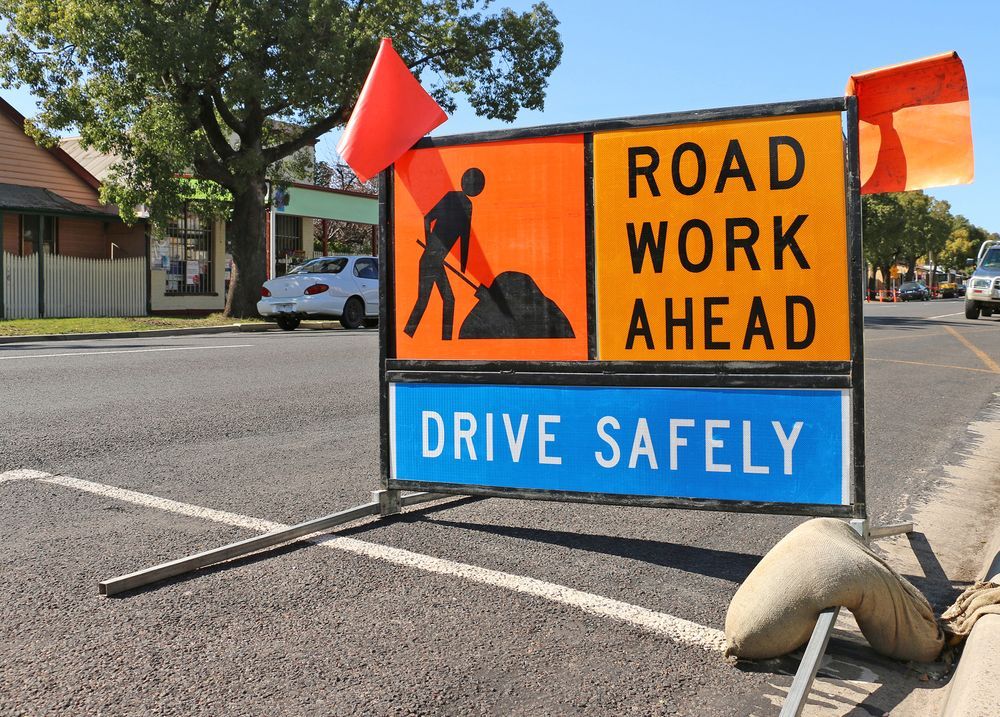 Road Work Sign on Asphalt Road with Worker Icon, Orange/blue Colors — Signvision In Dubbo, NSW