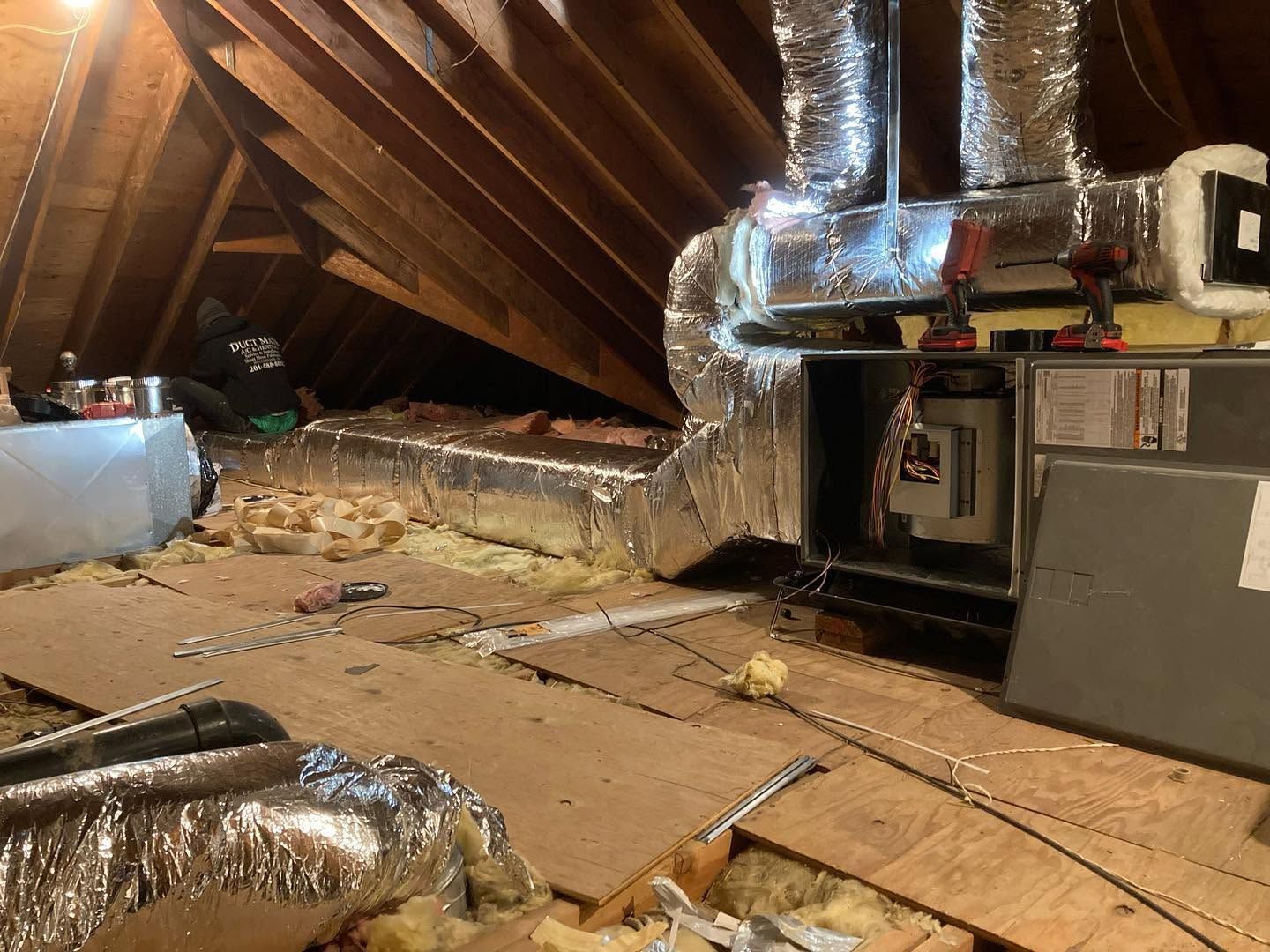 Damaged attic with collapsed wooden beams, torn insulation, and exposed ductwork and HVAC equipment Damaged attic with collapsed wooden beams, torn insulation, and exposed ductwork and HVAC equipment