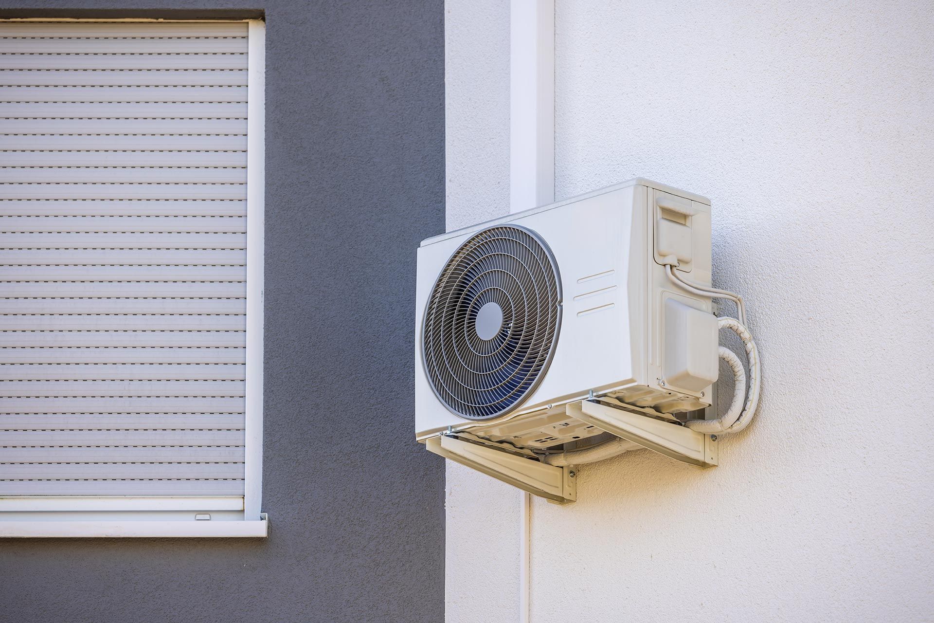 Air conditioner and heat pump installed on a wall. Air conditioner and heat pump installed on a wall.