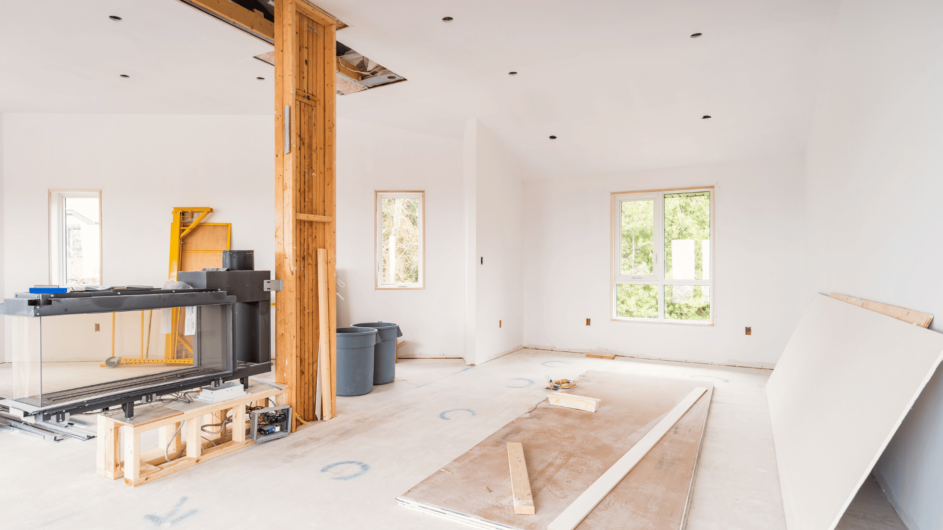 An empty room with a wooden pillar in the middle of it.