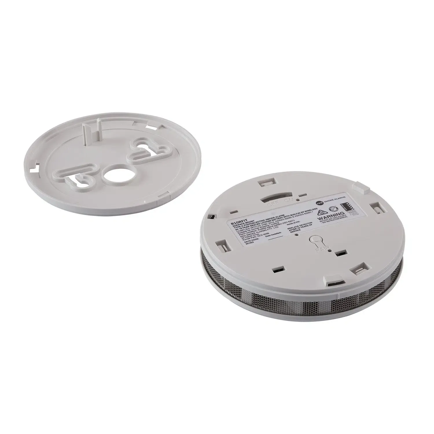 Two white smoke detector halves, one faceplate and one detector with label visible. — FNQ Smoke Alarms & Maintenance in Goldsborough, QLD