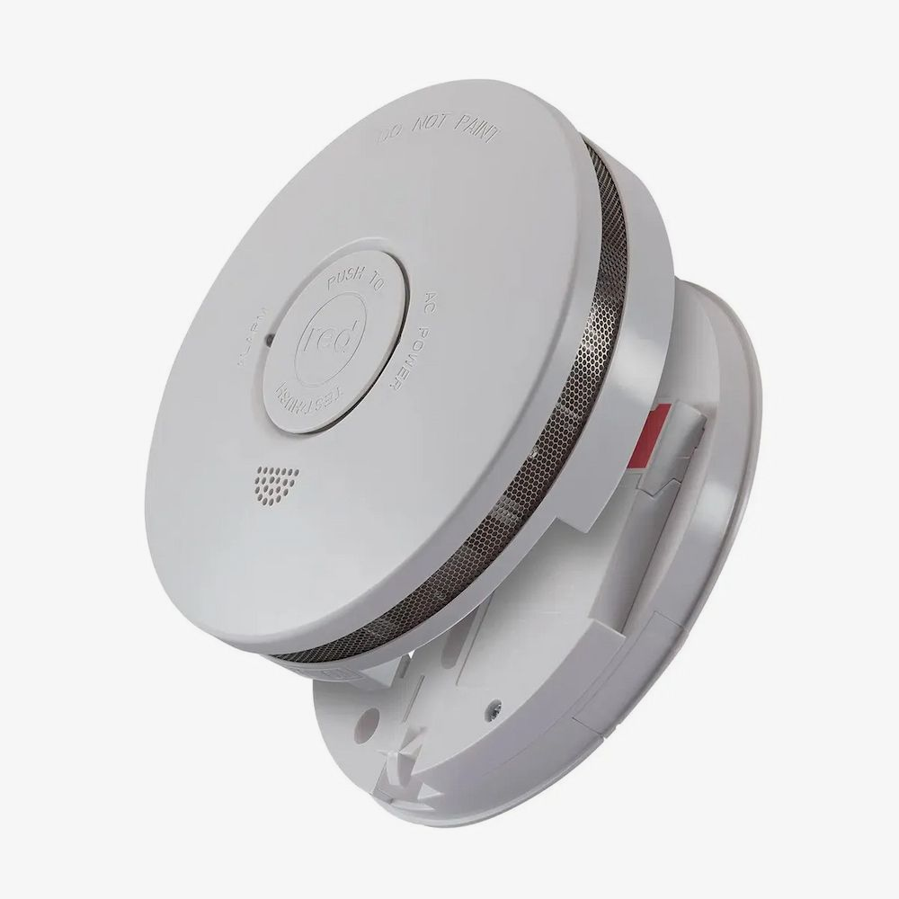White Smoke Detector, Partially Detached From Its Mounting Plate — FNQ Smoke Alarms & Maintenance in Goldsborough, QLD