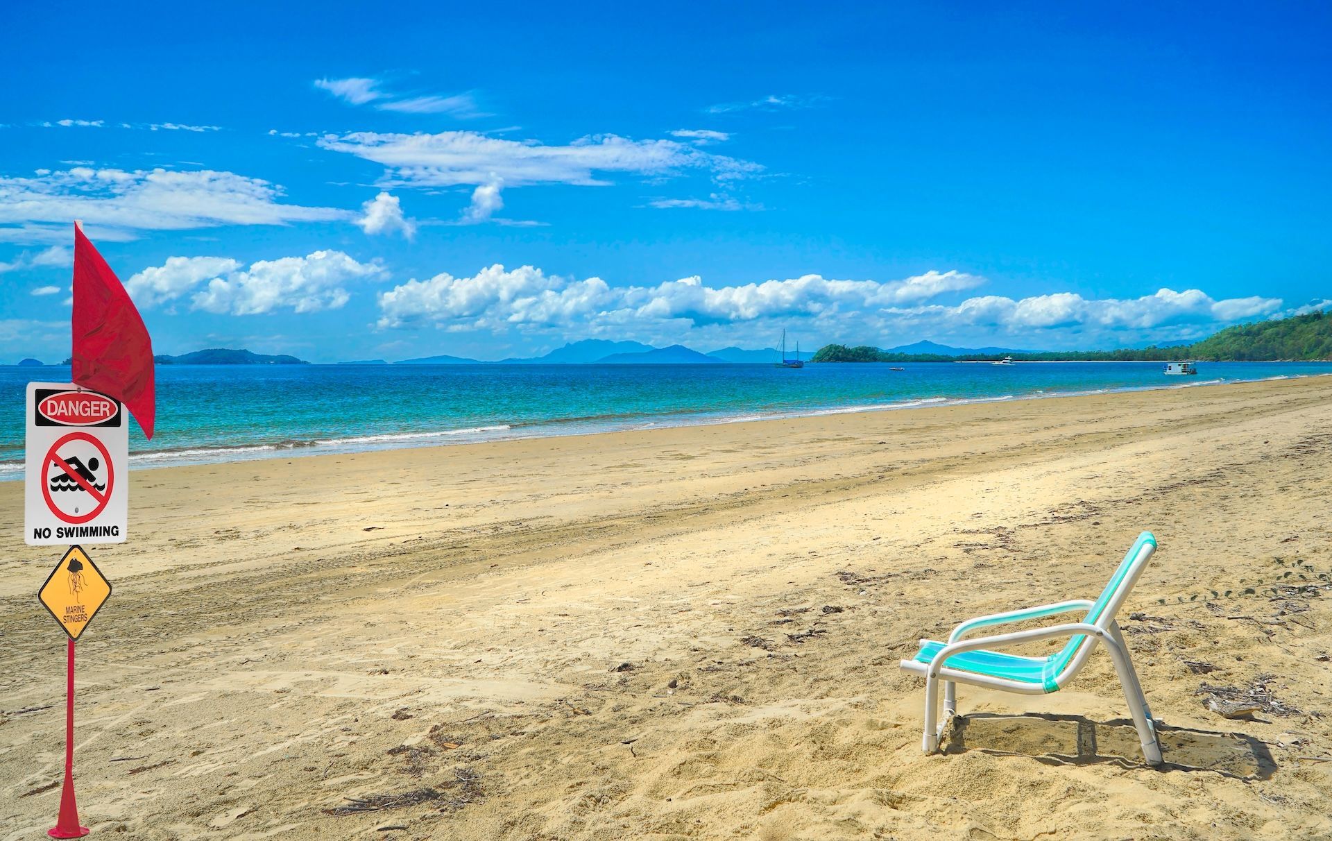Red Flag on a Beach Warns Against Swimming — FNQ Smoke Alarms & Maintenance in Mission Beach, QLD