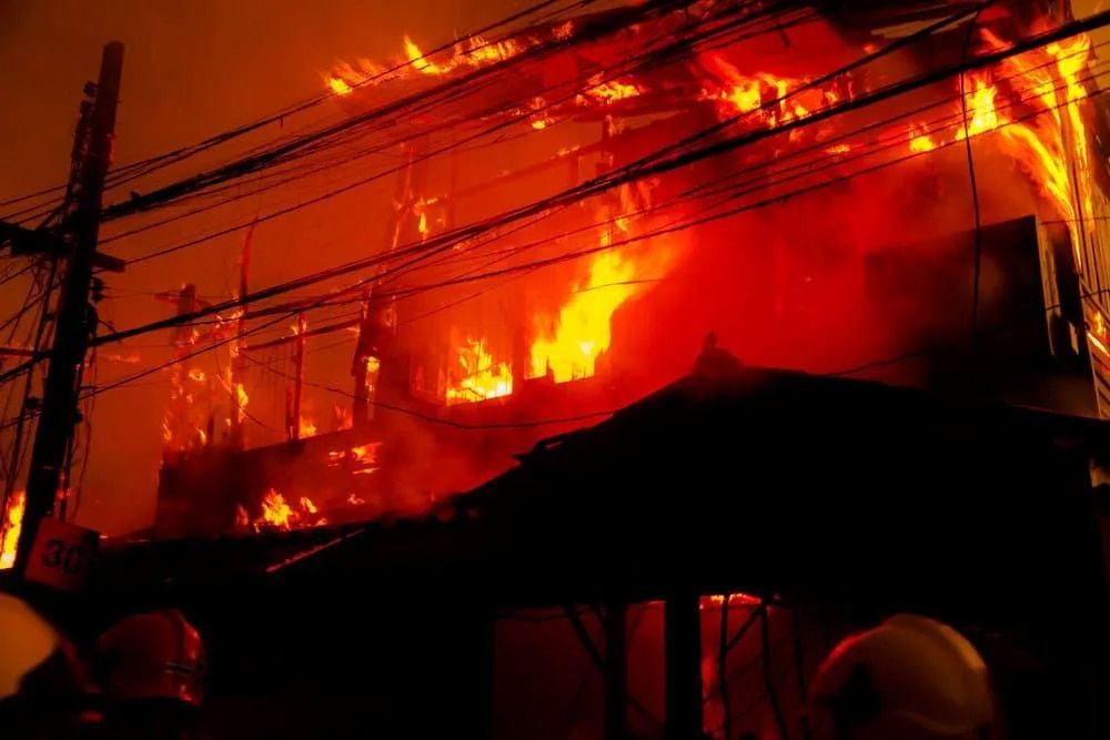 Building Engulfed in Flames, Bright Orange Fire Against Dark Sky — FNQ Smoke Alarms & Maintenance in Goldsborough, QLD