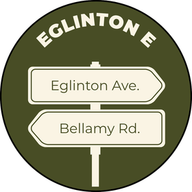 Eglinton E street sign with arrows for Eglinton Ave. and Bellamy Rd. on an olive green circular background