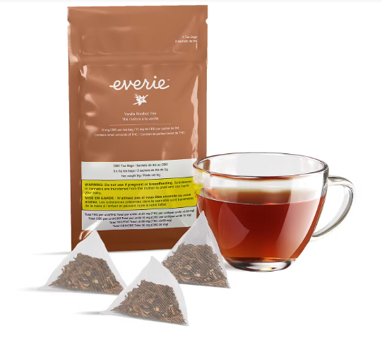 Brown tea package with three tea pyramid sachets and a glass cup of amber tea
