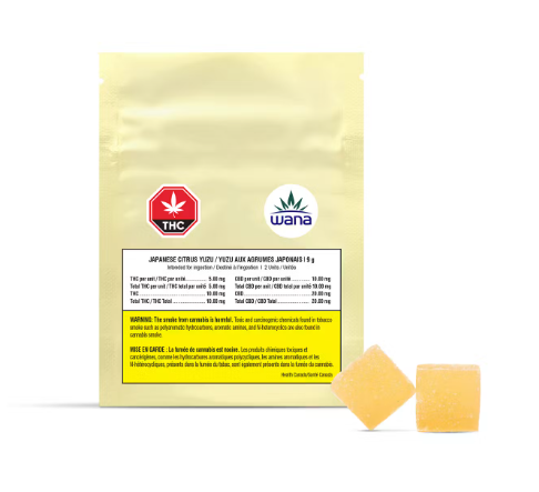 Yellow cannabis product pouch with THC and Wana logos, plus two orange gummies beside it