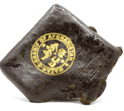 Dark brown wrapped food with a round yellow seal on top, shown on a white background