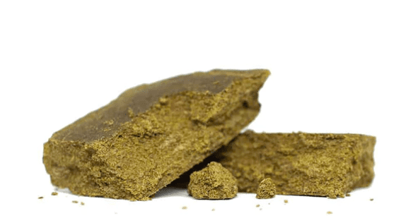 Brownish-yellow rock or mineral chunks on a white background