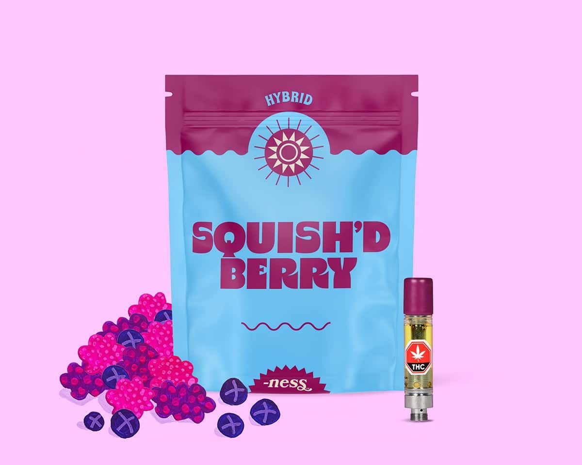 Pink and blue Squish'D Berry candy pouch with berry graphics and a small bottle beside it