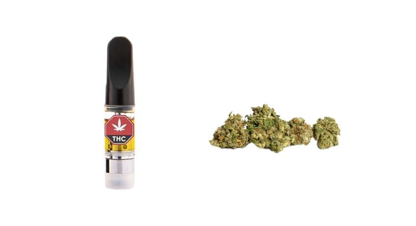 Cannabis vape cartridge beside a small pile of green marijuana buds on a white background