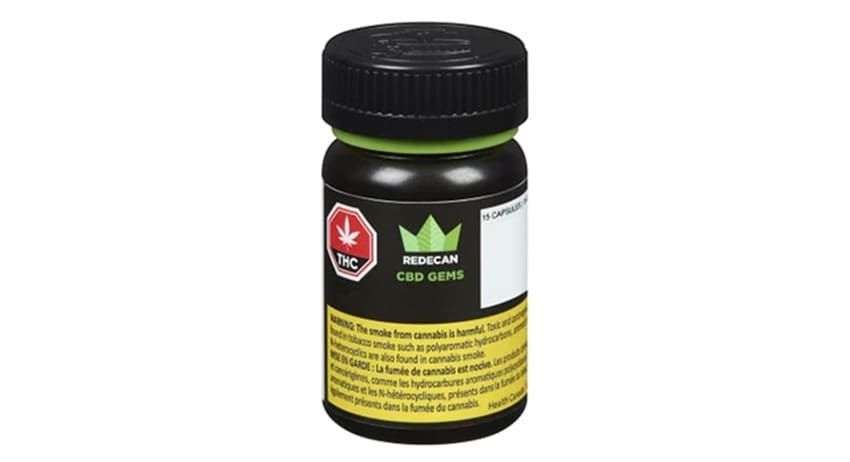 Small black bottle with green label and black cap on a white background