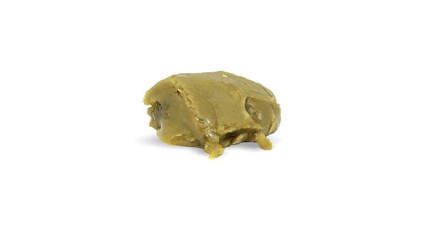 Small yellowish lump of clay or putty on a white background