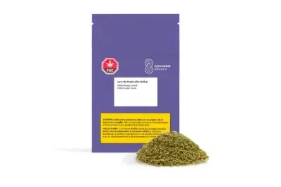 Purple product package with yellow label beside a pile of dried herbs
