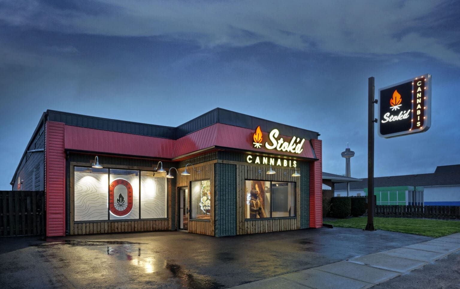 Small Steakhouse restaurant at dusk with warm lights and a roadside sign.