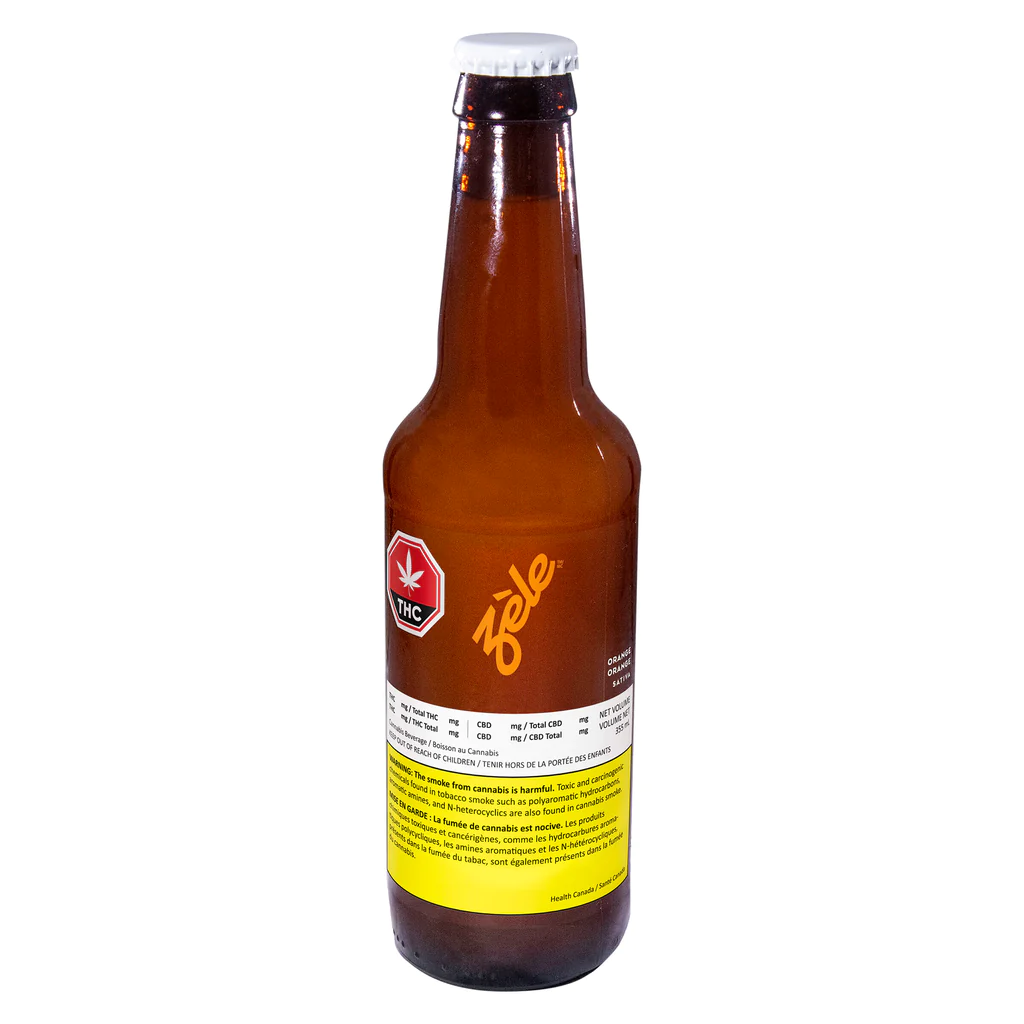 Amber beer bottle with yellow label and white cap on a white background