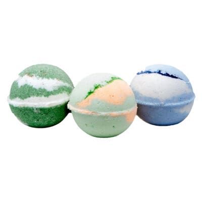 Three colorful cannabis-infused bath bombs in green, peach, and blue on a white background