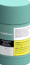 Teal Wildflower skincare jar with white and yellow label text.